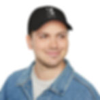 Smiling man in a denim jacket wears a black cap with a cat graphic and the text Another round? on a white background