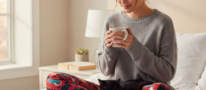 Cozy Cat Mom Wearing Cat Pajama Pants With Her Black Cat