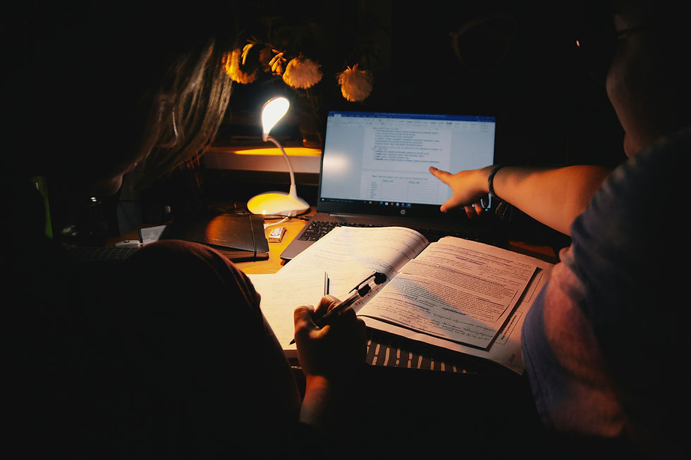 Students revising an essay draft to improve critical analysis and grading alignment