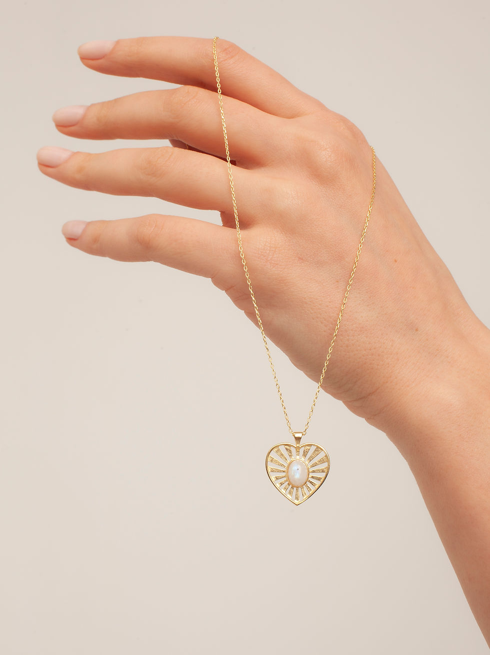 Hand showcasing Love Moonstone heart pendant necklace