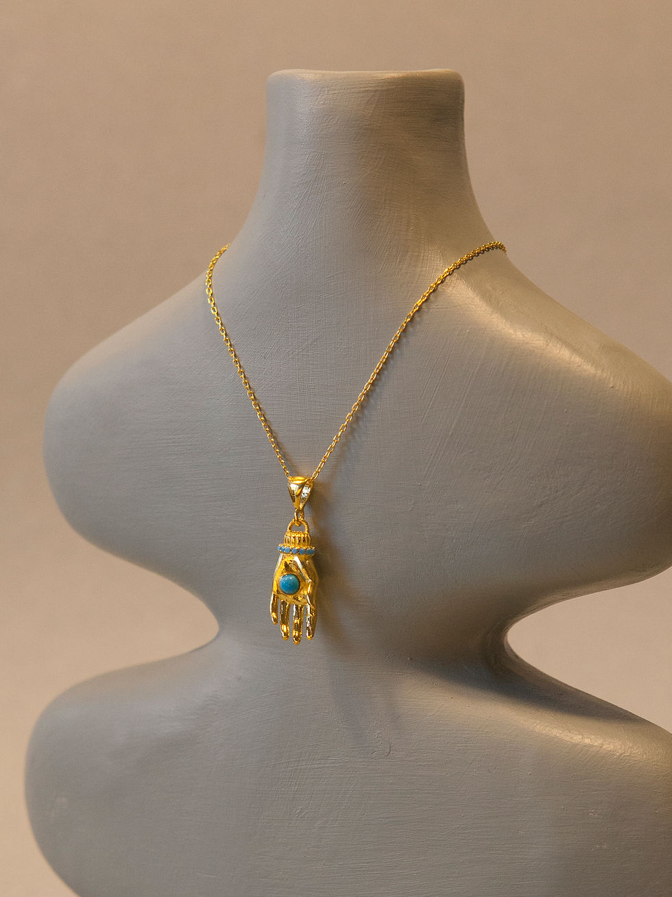 Gold Hamsa hand necklace with turquoise stone