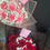 Thumbnail: Two bouquets of pink and red roses with white baby's breath arrangement.