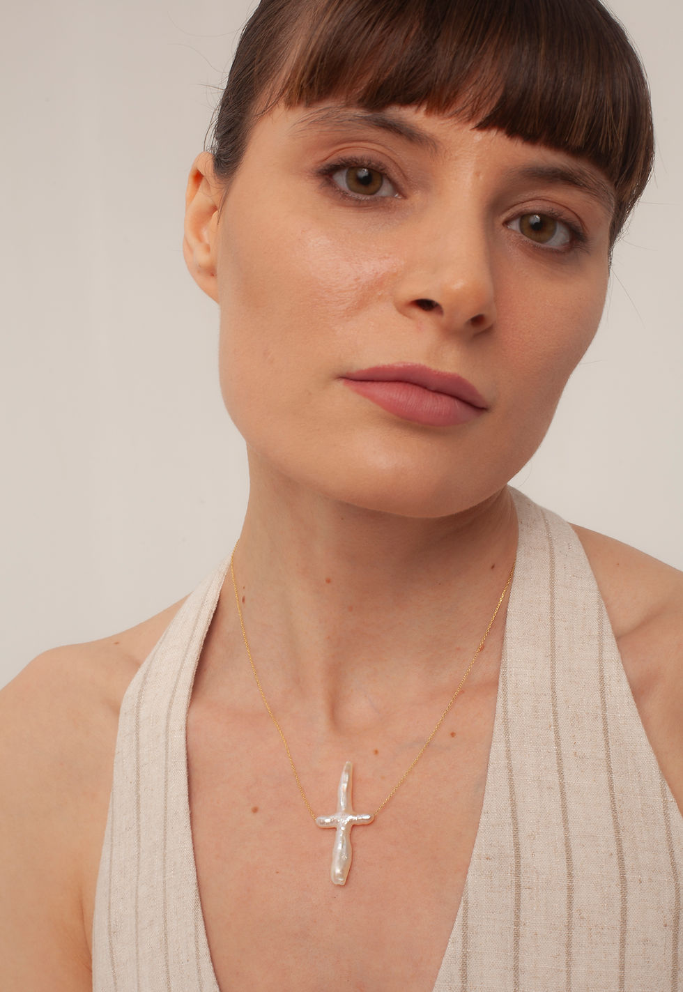 Woman wearing a diamond cross necklace