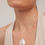 Thumbnail: Woman wearing pearl drop necklace