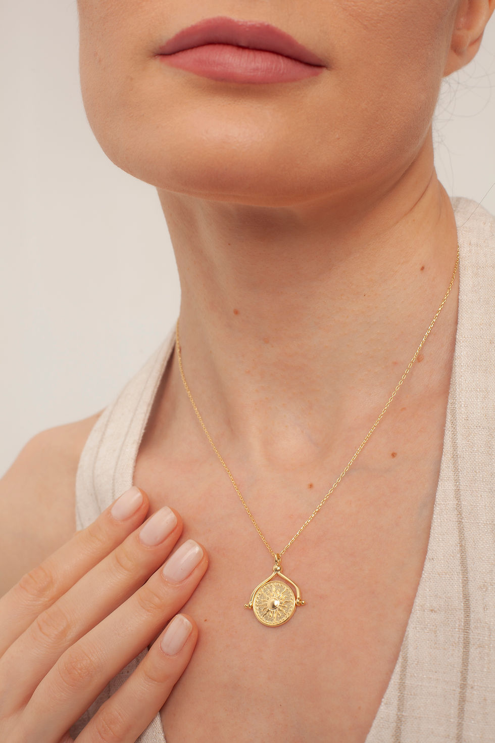 Woman wearing delicate gold necklace