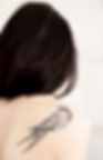 view-of-woman-s-back-with-bird-tattoo-on