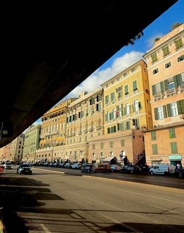 Pastel townhouses by a main road in Genoa Italy