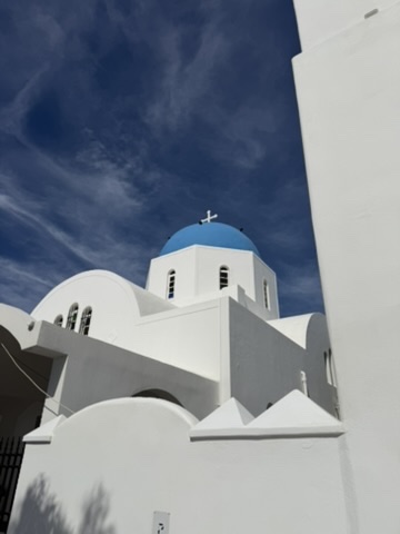 A church with a blue dome in Santorini, Greece