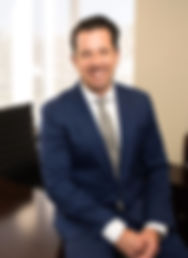 Profile picture of Dr. Frank Ciminello, MD sitting in office wearing a suit and tie.