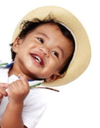 Young baby smiling looking away from camera.