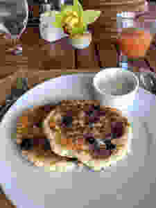 Made to order banana, blueberry and macadamia nut pancakes with coconut syrup