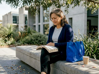 Woman reading Bible on Canberra park bench