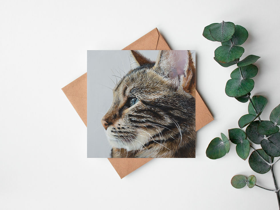 Bengal Cat Fine Art Greeting Card lying flat on a Kraft brown envelope with a sprig of eucalyptus beside it.