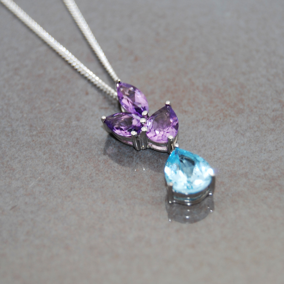 Elegant Blue Topaz and Amethyst Silver Pendant