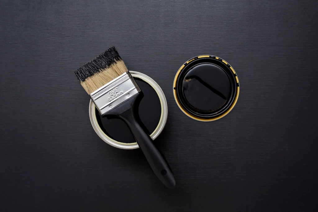 can-of-black-paint-with-brush.webp
