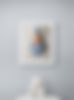 Framed baby boy portrait above a round table