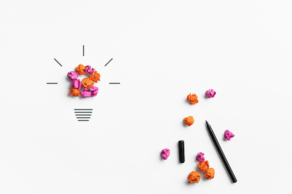 white background, conceptual image of brainstorming, made with crumpled balls of colorful paper, with black line drawing that creates a lightbulb image, several loose crumpled paper balls and a pen are on the center right of the background image. The title of the page is in the middle in text that reads "ideas I have written down"