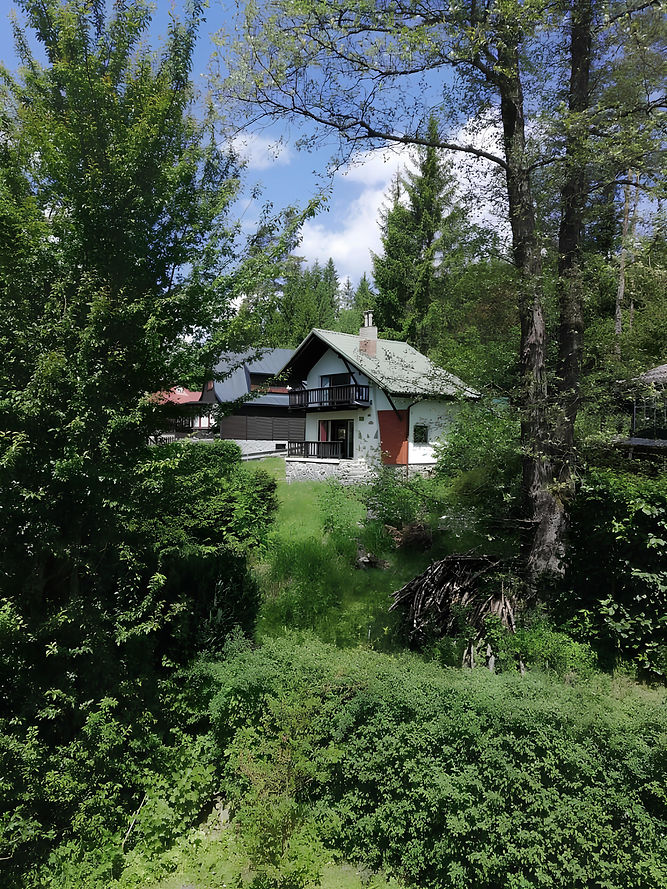White house in the woods, Czech Cottage, surrounded by trees and greenery