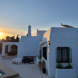 White villa at sunset. Pool and patio. Clear blue sky Villa de los Osos.