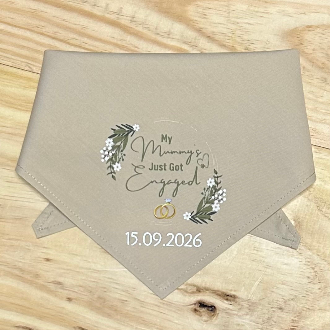 Beige dog bandana reading "My Mummy's Just Got Engaged" with florals, gold rings, and a custom date.