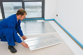 A man places down and aligns ideal eps panels