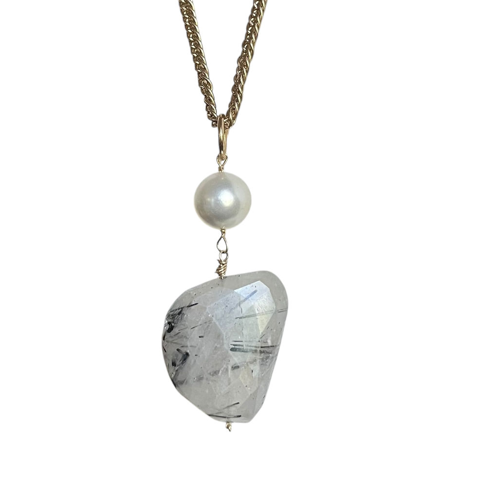 Thumbnail: Close up of natural tourmalated quartz pendant