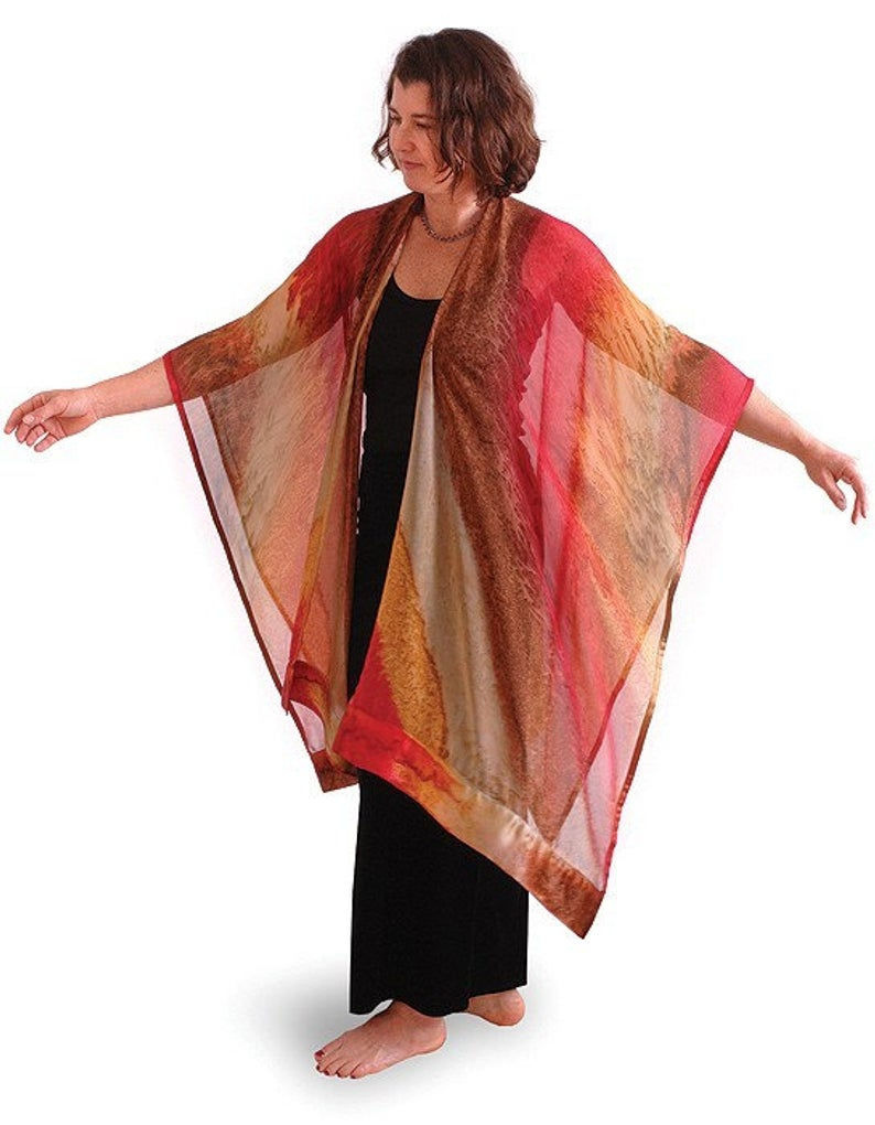 Thumbnail: Model wearing Maroc hand painted silk ruana, ombré of sunny gold, deepest red and golden beige