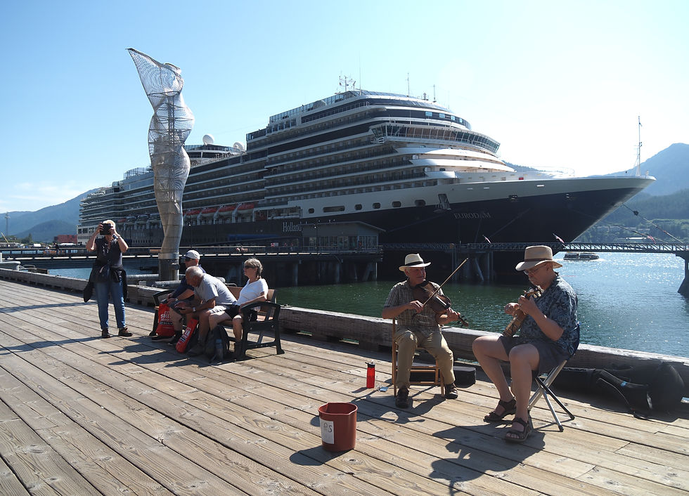 Tom Paul and John Fontanella busk on the Juneau Seawalk on July 28, 2025. (Natalie Buttner / Juneau Independent)