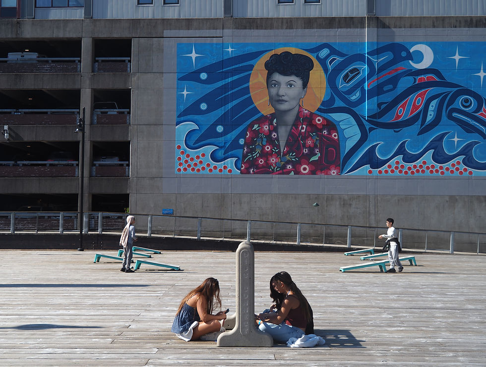 Children play on the pier near the Elizabeth Peratrovich mural on July 28, 2025. (Natalie Buttner / Juneau Independent)