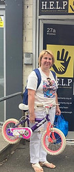 A ukrainian mother holding a bike for her daughter