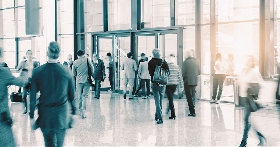 Entrance hall of London office with leaders and employees going in and out