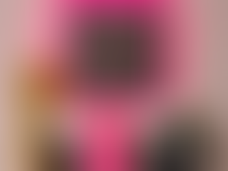 Gold mannequin, pink skull bottles, skincare products, neon pink square mirror, white brick wall, two small potted plants.