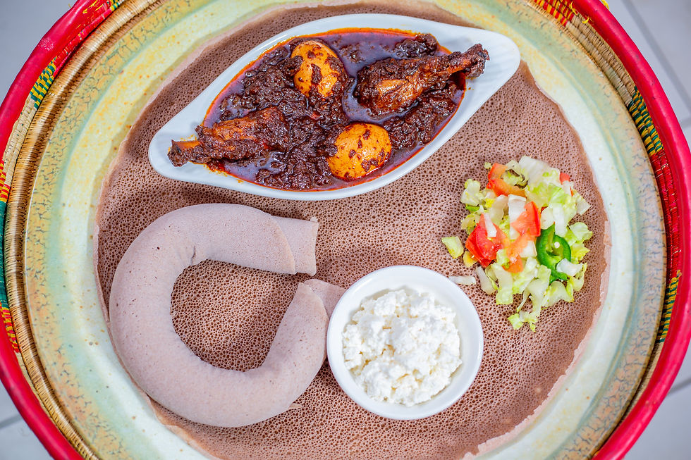 Eye-level view of a colorful Ethiopian fusion dish with injera and stews