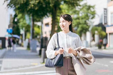 横断歩道を渡る仕事中の女性