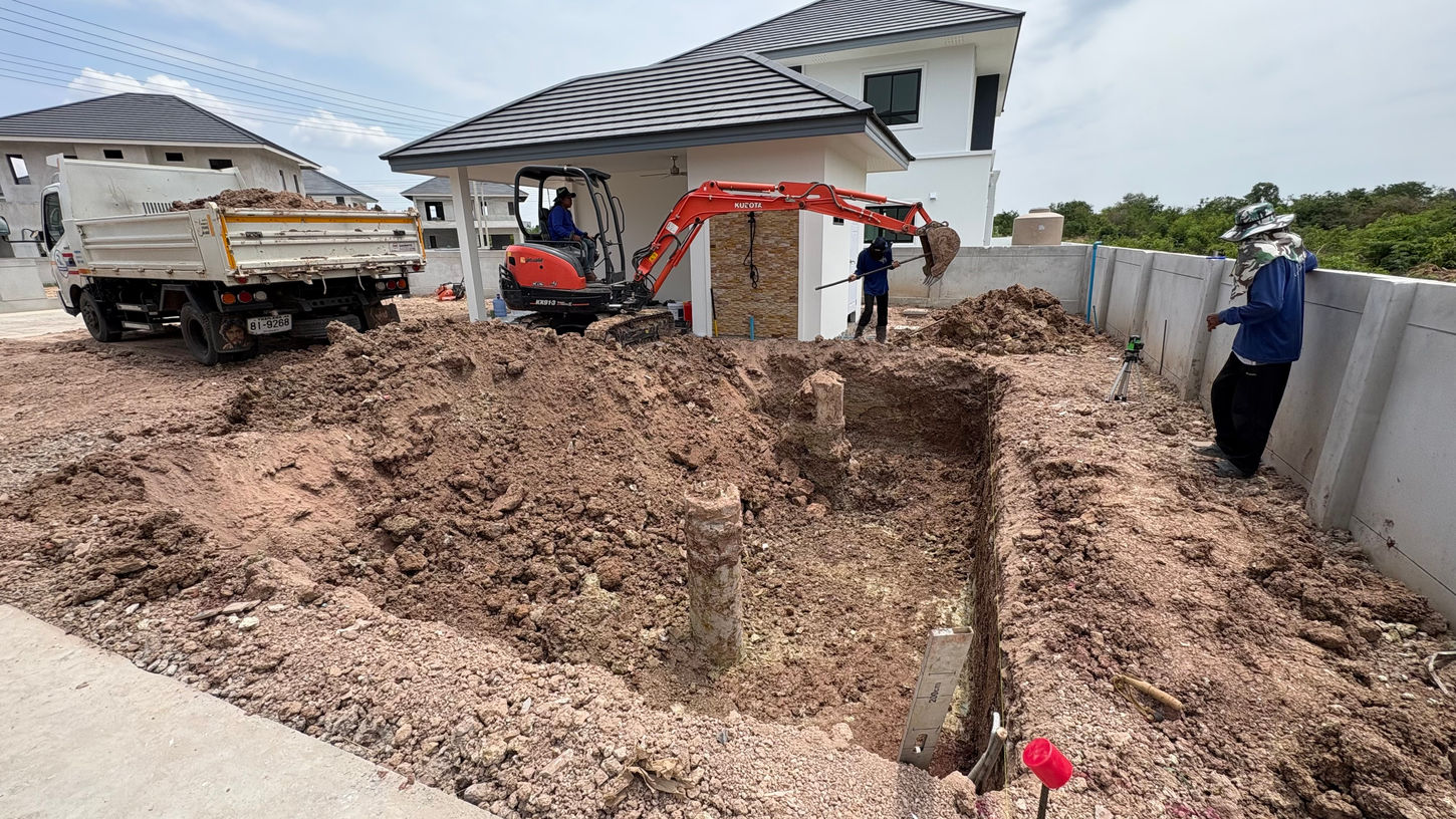 Excavator starting swimming pool excavation – concrete pool construction process in Isaan, Northeast Thailand.