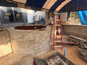 10x4 skimmer pool under construction with a round Jacuzzi and new concrete forms