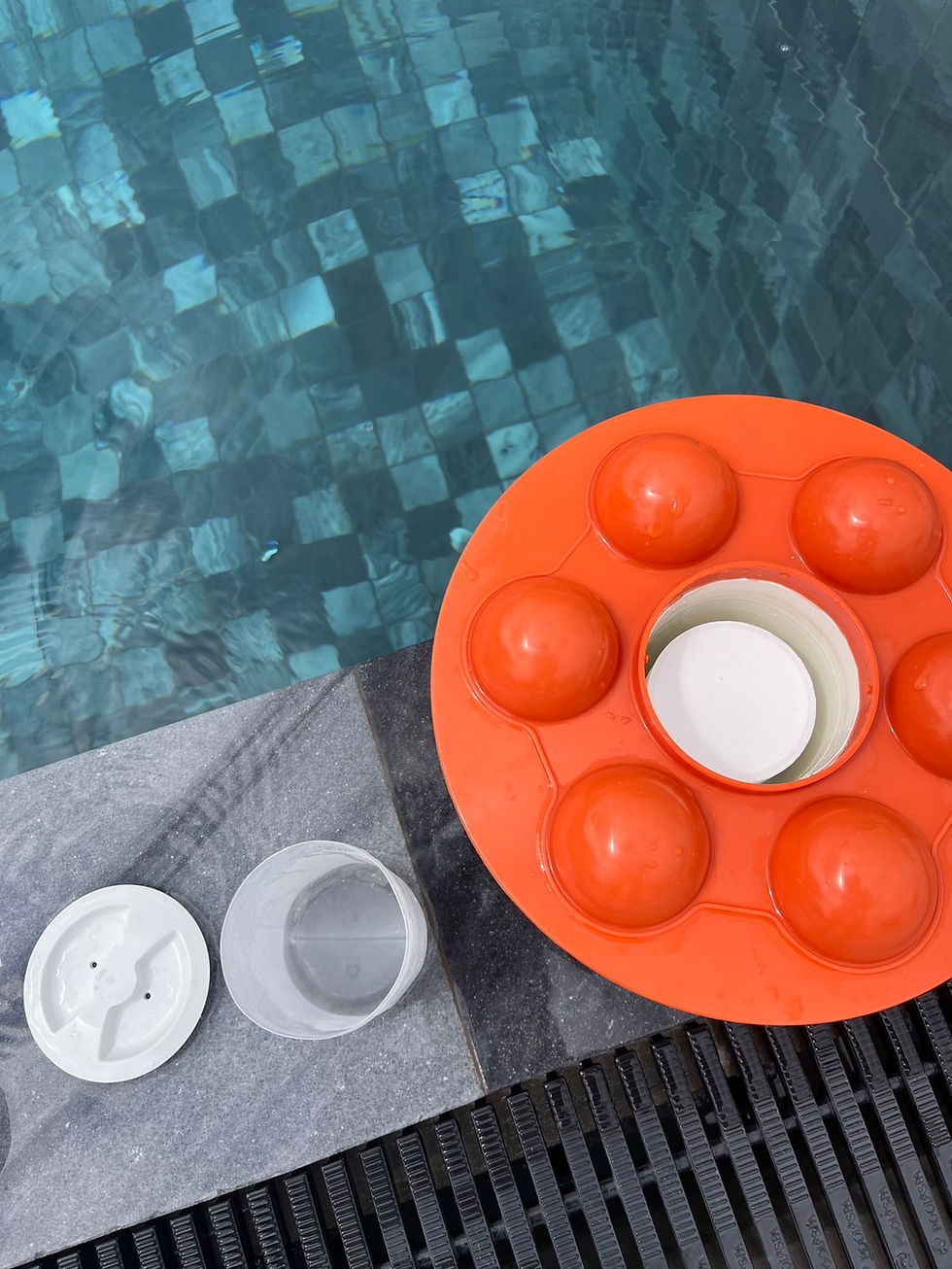 Swimming pool water with a floating chlorine dispenser during routine pool maintenance