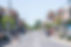 Busy high street scene with pedestrians and traffic