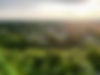 Aerial view of a town nestled in lush greenery at sunset