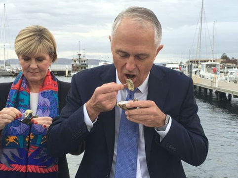 Prime Minister Malcolm Turnbull enjoys an unusual breakfast of oysters in Hobart