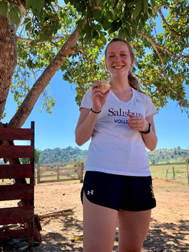 Rachel Dubbs holding an orange she just picked from a tree while at a farmer’s house in Ariquemes, Rondonia.