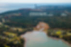 Aerial view of the proposed Spruce Lake Industrial Park expansion near Lorneville, New Brunswick, covering 871 acres of land marked for industrial development. This area includes vital ecosystems such as protected wetlands, coastal forests, freshwater streams, and residential communities. The expansion poses environmental risks to the ecosystem and local residents, highlighting the need for sustainable land use planning and climate-conscious development.