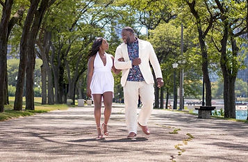 couple walking through Milton lee olive park in chicago while posing for engagement photos chicago engagement photographer engagement photographer photographed by pamela l king photography