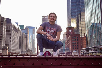 man posing on bridge on the chicago riverwalk for graduation photos photographed by pamela l king photography