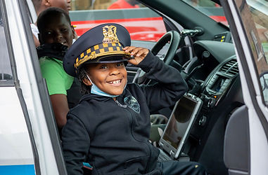 boy in police uniform sitting in a chicago police vehicle chicago police department photographed by Pamela l king photography