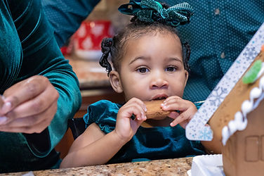 capturing a child eating a gingerbread cookie while on a gingerbread mini session photographed by pamela l king photography
