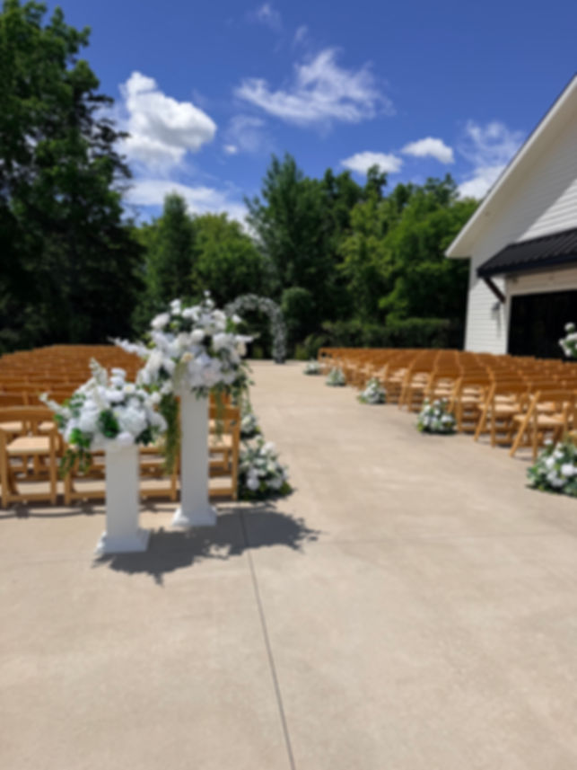 Wood Pillars with white delphinium flowers 