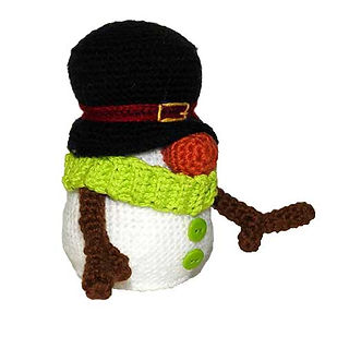 Side view of a gnome snowman crochet pattern with a black hat, green scarf, carrot nose, and twig arms.