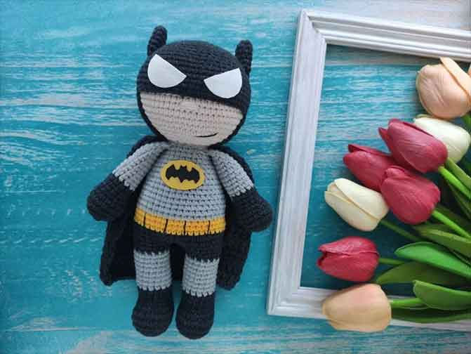 Batman crochet doll with black cape and logo on chest, a fun DC Comics crochet pattern for fans.