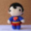 Superman crochet doll with black hair, red cape, and blue suit, a charming DC Comics crochet pattern.